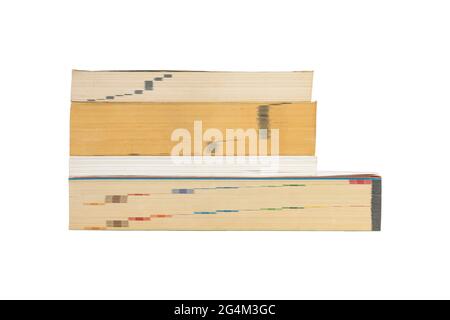 Closeup group of stacked thick books isolated on white background. Stock Photo