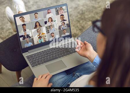 Woman having a virtual meeting with her business colleagues on her laptop computer Stock Photo