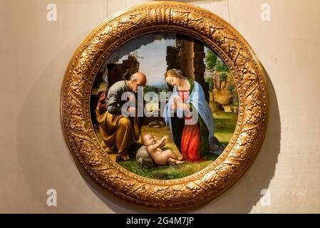 Medieval painting in a round frame showing Virgin Mary and  Saint Joseph looking at baby Jesus Stock Photo