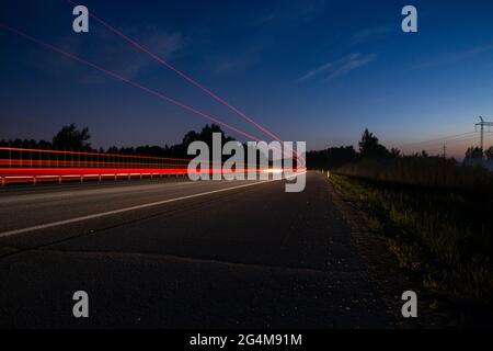 night track with blurred lights from the headlights of cars.long exposure time Stock Photo