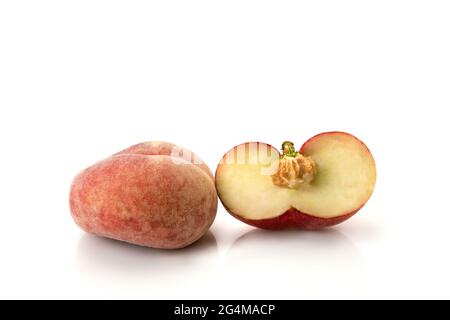 Donut peaches isolated on white background, one Saturn peaches cut in half with bone or seed and one whole Stock Photo