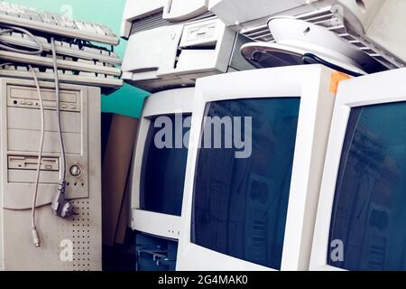 Vintage computers with CRT monitors . Out of use old computers . Pile of unused vintage electronic equipment Stock Photo