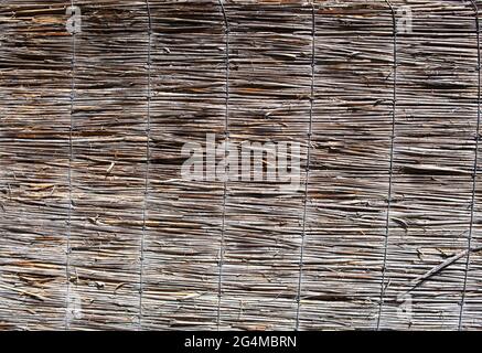 Wicker fence background. Wicker texture. Wooden fence. Old decorative surface. Stock Photo