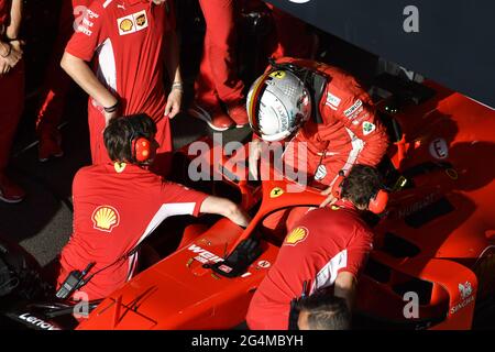 Ferrari's pit stop crew working around the Ferrari Formula One at the Ferrari' box, during an exhibition in MIlan, Italy. Stock Photo