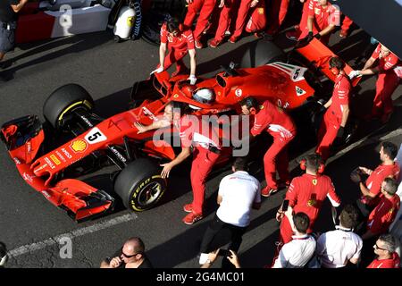 Ferrari's pit stop crew working around the Ferrari Formula One at the Ferrari' box, during an exhibition in MIlan, Italy. Stock Photo