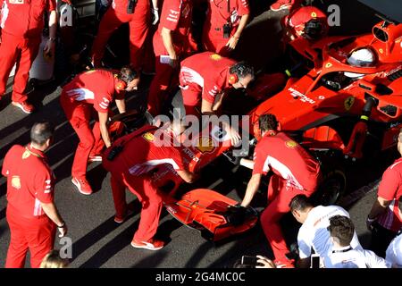 Ferrari's pit stop crew working around the Ferrari Formula One at the Ferrari' box, during an exhibition in MIlan, Italy. Stock Photo