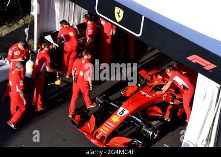 Ferrari's pit stop crew working around the Ferrari Formula One at the Ferrari' box, during an exhibition in MIlan, Italy. Stock Photo