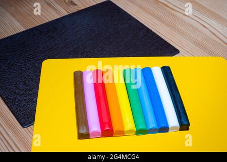 Colored plasticine on yellow board Stock Photo