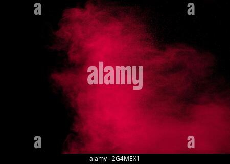 Pink powder explosion.Pink dust splash cloud on dark background. Stock Photo