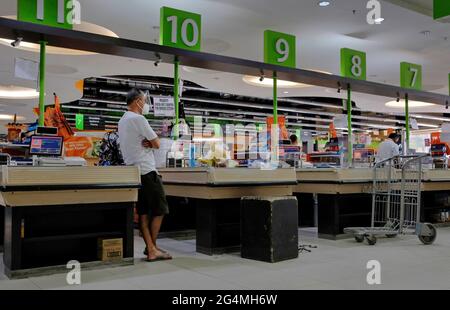 Cebu City, Philippines; June 19, 2021 -- Sparse checkout counter at a relatively small supermarket, typical scenario in the current pandemic economy. Stock Photo