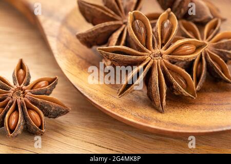 Star anise on wooden spoon. Cooking Spice. Illicium verum Stock Photo
