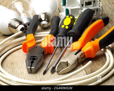 set of electrician tools, equipment and a coil of wire Stock Photo