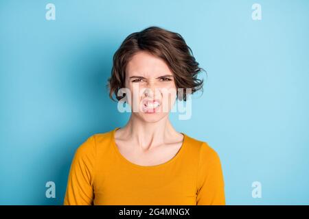 Photo of angry brunette lady show teeth wear yellow shirt isolated in vivid blue color background Stock Photo