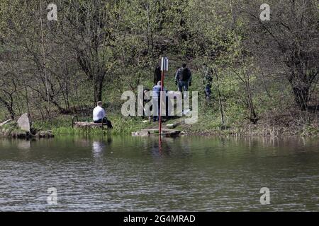 May 3, 2020, Moscow, Russia: An OMON (riot police) patrol communicates with violators on the shore of the reservoir.In the spring of 2020, due to the outbreak of a new coronavirus infection in Moscow, anti-epidemiological measures were introduced. Without unnecessary necessity, citizens were advised not to go out into public places and all movement around the city had to be carried out in medical protective equipment and with an electronic pass. Enforcement of restrictive measures on the streets of the city was monitored by the police and the National Guard. River boats, drones and Ka-226 hel Stock Photo