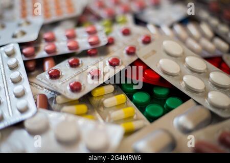 A pile of multi-colored pills lie one on one Stock Photo