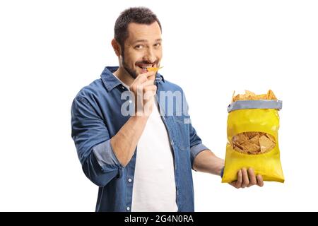 Handsome young man eating tortilla chips isolated on white background Stock Photo
