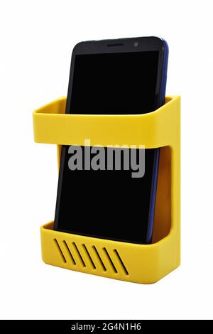 Wall mounted plastic organizer rack with mobile in it Stock Photo