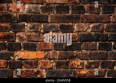 Brick wall. Red burnt brick. Background or texture of blocks of different colors. Stock Photo