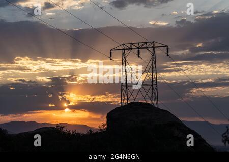 Electric power pylon sunrise at Santa Susana Pass State Historic Park in Los Angeles County, California. Stock Photo
