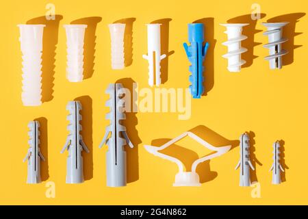 Top view of plastic dowels of different sizes with holes on ribbed surface in row Stock Photo