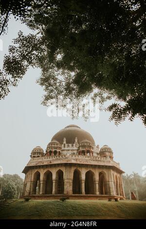 Low angle of historic Mohammed Shahs tomb with columns located in garden with trees Stock Photo