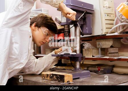 young male industrial worker doing job on the factory manufacture, industrial profession Stock Photo