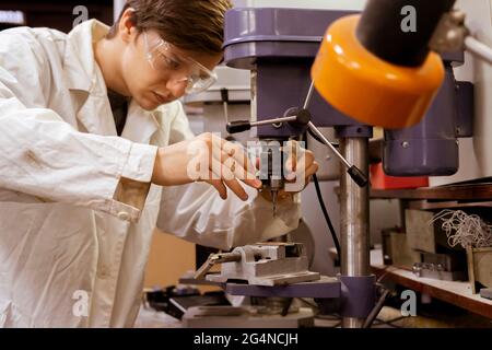 young male industrial worker doing job on the factory manufacture, industrial profession Stock Photo