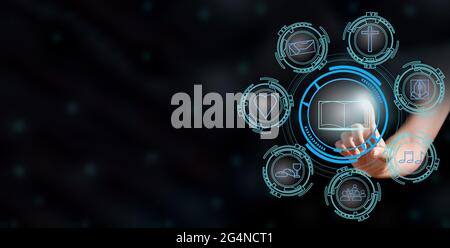 woman's hand touching glowing open bible in the center of futuristic interface screen with icons Christianity. Stock Photo
