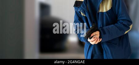 close up terrorist with a black pistol in public street place of the city Stock Photo