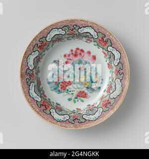 Soup Plate With a Large Lotus and Insects. Porcelain soup plate, painted on the glaze in blue, red, pink, green, yellow, black and gold. On the flat one peony and a large lotus with leaf. On the leaf a flower branch, butterfly, beetle and dragonfly. On the wall and edge a complicated decorative bond with cartouches with flower drinks against napkin and four rectangular compartments with squeezed corners with a landscape; The edge with a band with curl work with half floral rosettes. The back with four mushrooms (Lingzhi). Some chips in the edge. Family Rose. Stock Photo