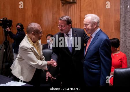 Former United States Senator Joseph I. Lieberman (Independent of Connecticut), right, and Delegate Eleanor Holmes Norton (Democrat of the District of Columbia), left, are greeted by United States Senator Gary Peters (Democrat of Michigan), Chairman, US Senate Committee on Homeland Security and Government Affairs, center, as they arrive for a Senate Committee on Homeland Security and Governmental Affairs hearing to examine D.C. statehood, in the Dirksen Senate Office Building in Washington, DC, Tuesday, June 22, 2021. Credit: Rod Lamkey/CNP /MediaPunch Stock Photo
