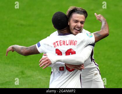 England's Raheem Sterling (left) celebrates scoring their side's first goal of the game with Jack Grealish during the UEFA Euro 2020 Group D match at Wembley Stadium, London. Picture date: Tuesday June 22, 2021. Stock Photo