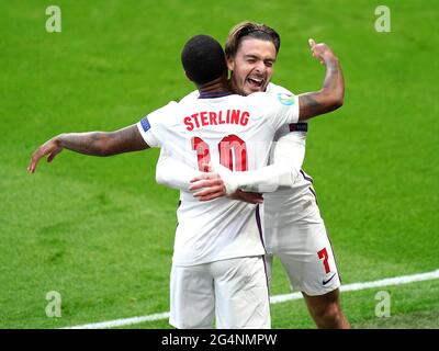 England's Raheem Sterling (left) celebrates scoring their side's first goal of the game with Jack Grealish during the UEFA Euro 2020 Group D match at Wembley Stadium, London. Picture date: Tuesday June 22, 2021. Stock Photo