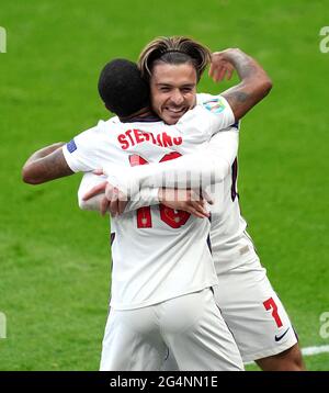 England's Raheem Sterling (left) celebrates scoring their side's first goal of the game with team-mate Jack Grealish during the UEFA Euro 2020 Group D match at Wembley Stadium, London. Picture date: Tuesday June 22, 2021. Stock Photo