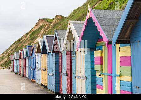 Pretty beach huts on Sheringham seafront seen in June 2021 on the North Norfolk coast. Stock Photo