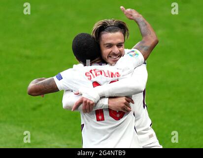 England's Raheem Sterling (left) celebrates scoring their side's first goal of the game with team-mate Jack Grealish during the UEFA Euro 2020 Group D match at Wembley Stadium, London. Picture date: Tuesday June 22, 2021. Stock Photo