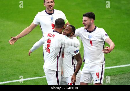 England's Raheem Sterling (centre) celebrates scoring their side's first goal of the game with Kyle Walker (left), Harry Kane and Declan Rice (right) during the UEFA Euro 2020 Group D match at Wembley Stadium, London. Picture date: Tuesday June 22, 2021. Stock Photo