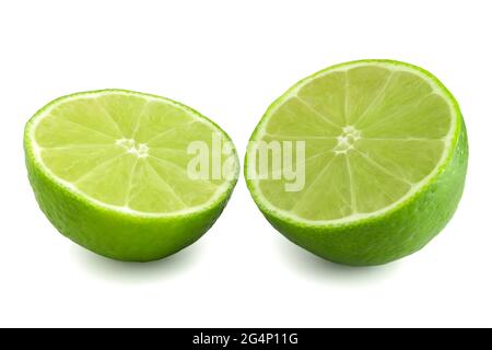 Two halves of lime isolated on white background. Fresh citrus cut in half. Green fruit full focus. Stock Photo