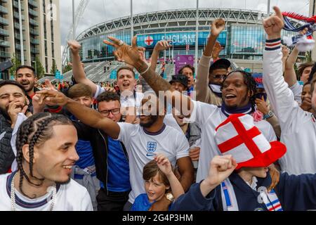 Wembley Stadium, Wembley Park, UK. 22nd June 2021.   England fans singing England's official anthem 'OLE (We Are England 21)' with London based duo, hip hop artists and rappers, Krept and Konan on Olympic Way.  Englands vs Czech Republic, both teams final Group D match of the UEFA European Football Championship, kicks off at 8pm at Wembley Stadium.   Amanda Rose/Alamy Live News Stock Photo