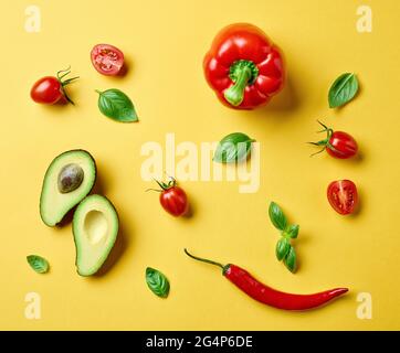 flat lay composition of various fresh raw vegetables on yellow background, top view Stock Photo