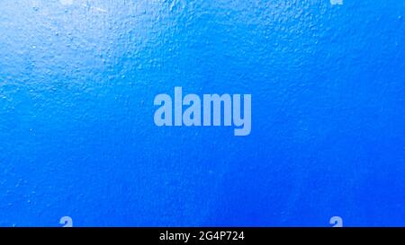 blue concrete wall as background painted in dark blue Stock Photo