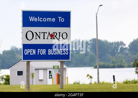 Hawkesbury, Ontario, Canada - June 21, 2021: A sign on Ile de Chenail welcomes motorists crossing from Grenville, Quebec to Ontario with the 'Open for Stock Photo