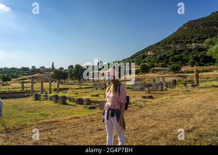 Messini, Greece - June 20 2021: Tourists visit the Ruins in the Ancient Messene archeological site, Peloponnese, Greece. One of the best preserved anc Stock Photo