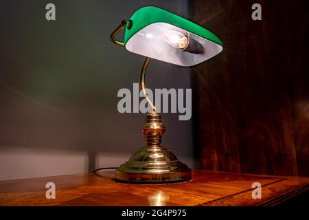 Vintage retro table lamp with green shade and electrical light bulb Stock Photo