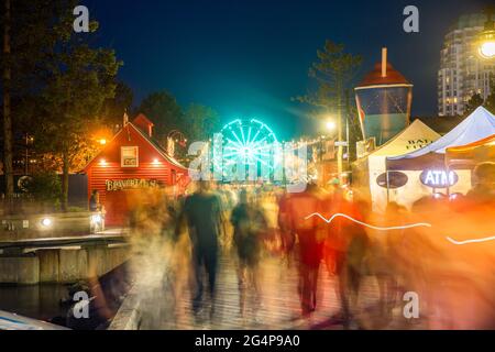 Bustling nightlife during summer at the Halifax harbor front waterfront on the Natal Day weekend at the Halifax Harbor, Nova Scotia, Canada Stock Photo