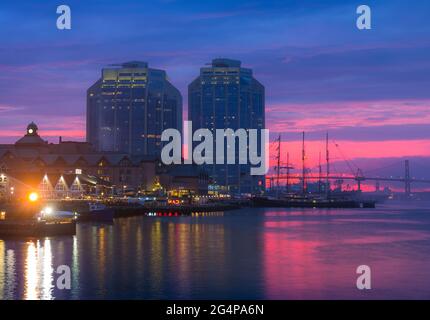 The bustling Halifax Harbor front waterfront on a beautiful summer evening during a very romantic sunset. Halifax waterfront during golden hour. Stock Photo