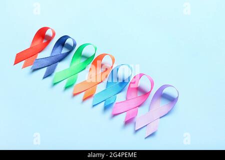 Different awareness ribbons on color background Stock Photo