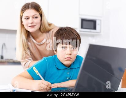 Family doing homework at kitchen Stock Photo