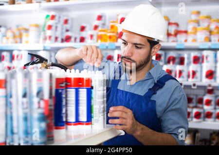Concentrated adult handyman choosing materials Stock Photo