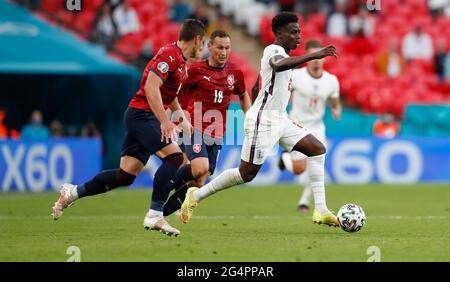 London, Britain. 22nd June, 2021. England's Bukayo Saka (R, Front) breaks through during the Group D match between England and the Czech Republic at the UEFA EURO 2020 in London, Britain, on June 22, 2021. Credit: Han Yan/Xinhua/Alamy Live News Stock Photo